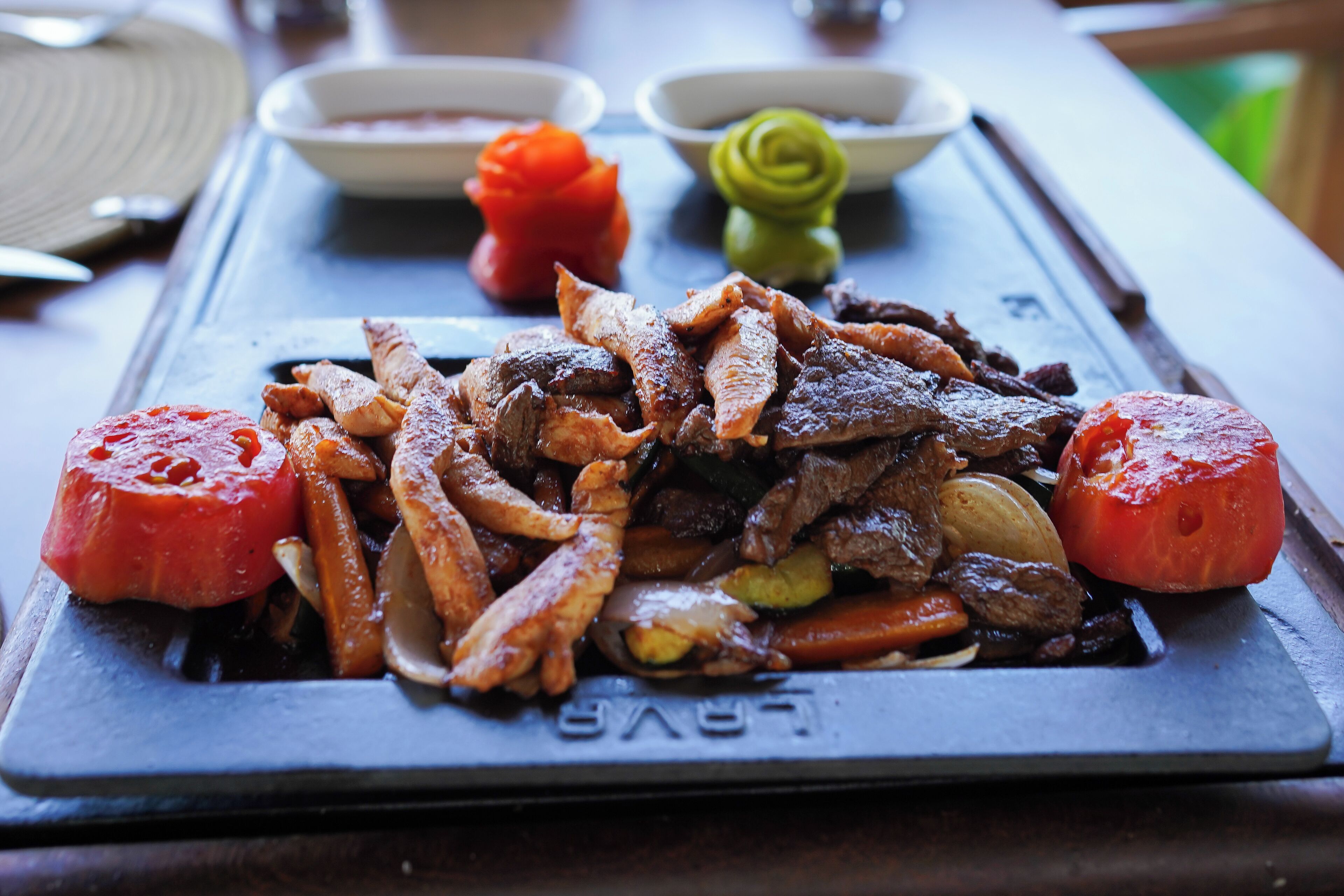 A plate of food with various meats and vegetables.