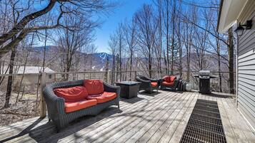 Relax on the deck with a wicker sofa and enjoy scenic views of the surrounding mountains.
