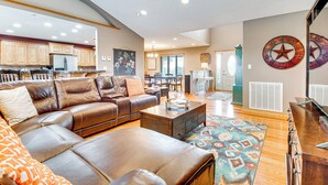 A spacious living room with a leather sofa, a coffee table, and a patterned rug. - Family-friendly Ozarks Getaway < 21 Mi to Branson! (Omaha)