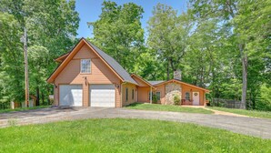 A two-story house with a garage and a small porch. - Access to Rough River Lake! Family Home w/ Deck (Leitchfield)