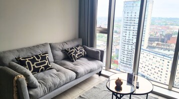 One Bedroom Apartment | Living area | 30-inch plasma TV with digital channels