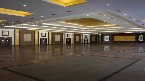 A spacious hotel lobby with a polished floor, recessed lighting, and a modern ceiling design. - Flamingo Tourist Resort (Hisar)