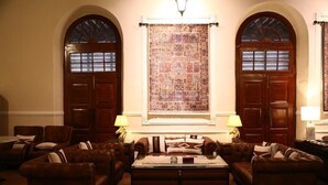 A traditional room with a large window, two doors, and a central fireplace. - Peshawar Barracks Estb 1867 (Peshawar)