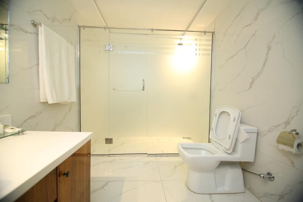 Ein Badezimmer mit Dusche, Toilette und Waschbecken.