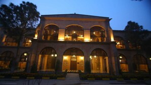 A building with a symmetrical facade, multiple arched windows, and a central entrance. - Peshawar Barracks Estb 1867 (Peshawar)