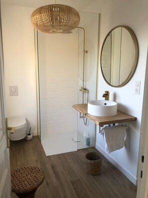 A modern bathroom with a glass shower enclosure, a round mirror, a white sink, and a wooden vanity. - Rossignol - Three Bedroom Villa, Sleeps 6 (Roquebrune-sur-Argens)