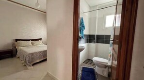Cozy retreat with a bed, bathroom, and amenities for a comfortable stay.