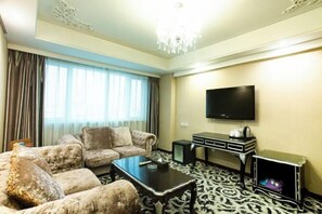 A living room with a sofa set, a coffee table, a flat-screen TV, a small TV, and a cabinet. - Mei Li Hua Hotel (Dezhou)