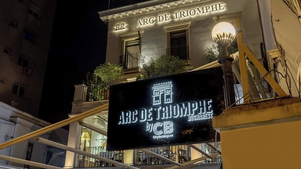 The exterior of the Arc de Triomphe Bucharest hotel with a signboard displaying its name and logo. - Arc de Triomphe by CityBookings (Bucharest)