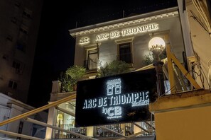 The exterior of the Arc de Triomphe Bucharest hotel with a signboard displaying its name and logo. - Arc de Triomphe by CityBookings (Bucharest)