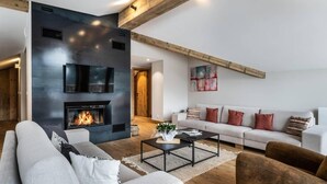 A modern living room with a fireplace, a sofa set, and a coffee table. - 100m from ski slopes, 4th floor, view mountain, balcony, tv, 200m², Champagny-en-Vanoise (Champagny-en-Vanoise)