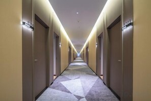 A hotel corridor with doors numbered 3203 and 3204, carpeted with a geometric pattern, and a ceiling with recessed lighting. - City 118 Chain Hotel Zhengzhou Economic Development Zone (Zhengzhou)