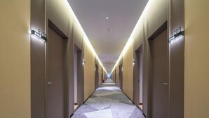 A hotel hallway with a geometric carpet pattern, doors numbered 8209 and 8203, and a ceiling with recessed lighting. - City 118 Chain Hotel Zhengzhou Economic Development Zone (Zhengzhou)