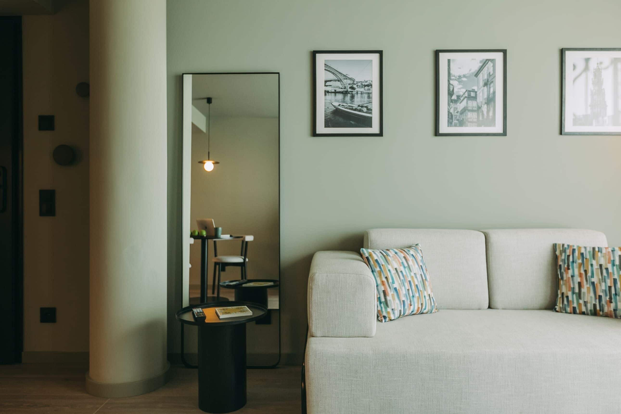 A modern living room with a sofa, a coffee table, and framed pictures on the wall.