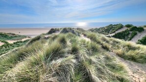A beach with dunes and a clear sky. - Seaside beach themed home with garden and driveway (Lytham St Annes)