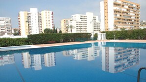 A swimming pool with reflections of surrounding buildings.