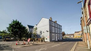 A street view with a building that has a modern facade and multiple windows. - Cumberland Hotel (Workington)