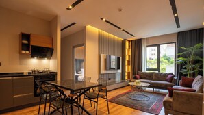 A modern living space with a kitchen, dining area, and seating area. - TRAY TRABZON  (Yomra)