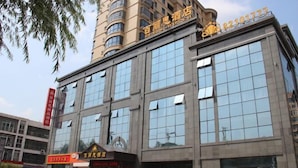 A multi-story building with large windows and a sign indicating a hotel. - Bailisi Hotel (Lianyungang)