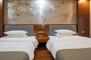 A hotel room with two beds, a wooden headboard, and a wall mural of flowers and birds. - Renhuai Shengshi Chain Hotel (Renhuai)