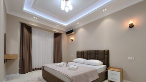 Family Quadruple Room, Balcony, Garden View | Desk, iron/ironing board, WiFi (free), bed sheets - Baurum Family Apartments (Tashkent)