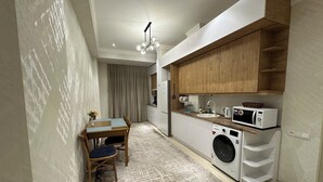 Comfort Quadruple Room | Private kitchen | Fridge, microwave, griddle, cookware/dishes/utensils - Baurum Family Apartments (Tashkent)