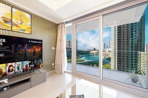 Enjoy a panoramic city view from the comfort of this stylish room, featuring a flat-screen TV and a cozy seating area.