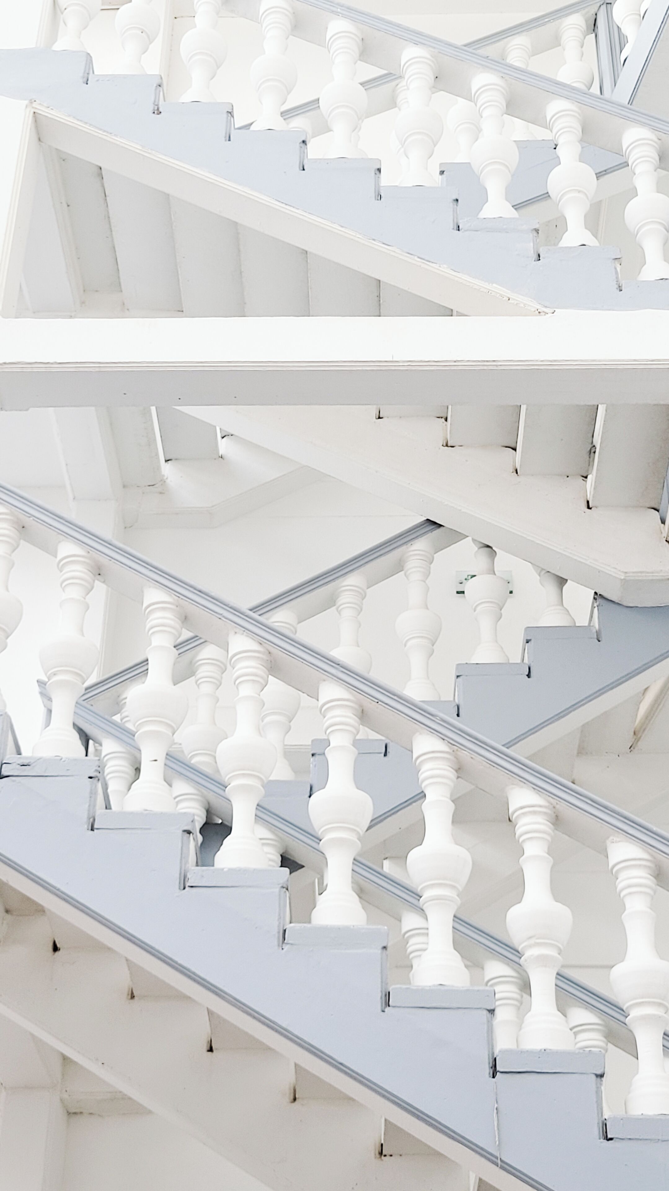 A staircase with white balustrades and a modern design.