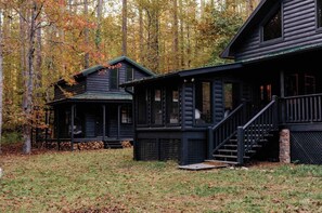 A cabin with a porch and stairs, surrounded by trees with autumn foliage. - Holden Haus | Creekside Cabin + Hot Tub + Dogs (Ellijay)