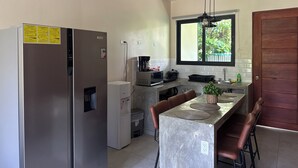 Una cocina moderna equipada con refrigerador, microondas y cafetera.