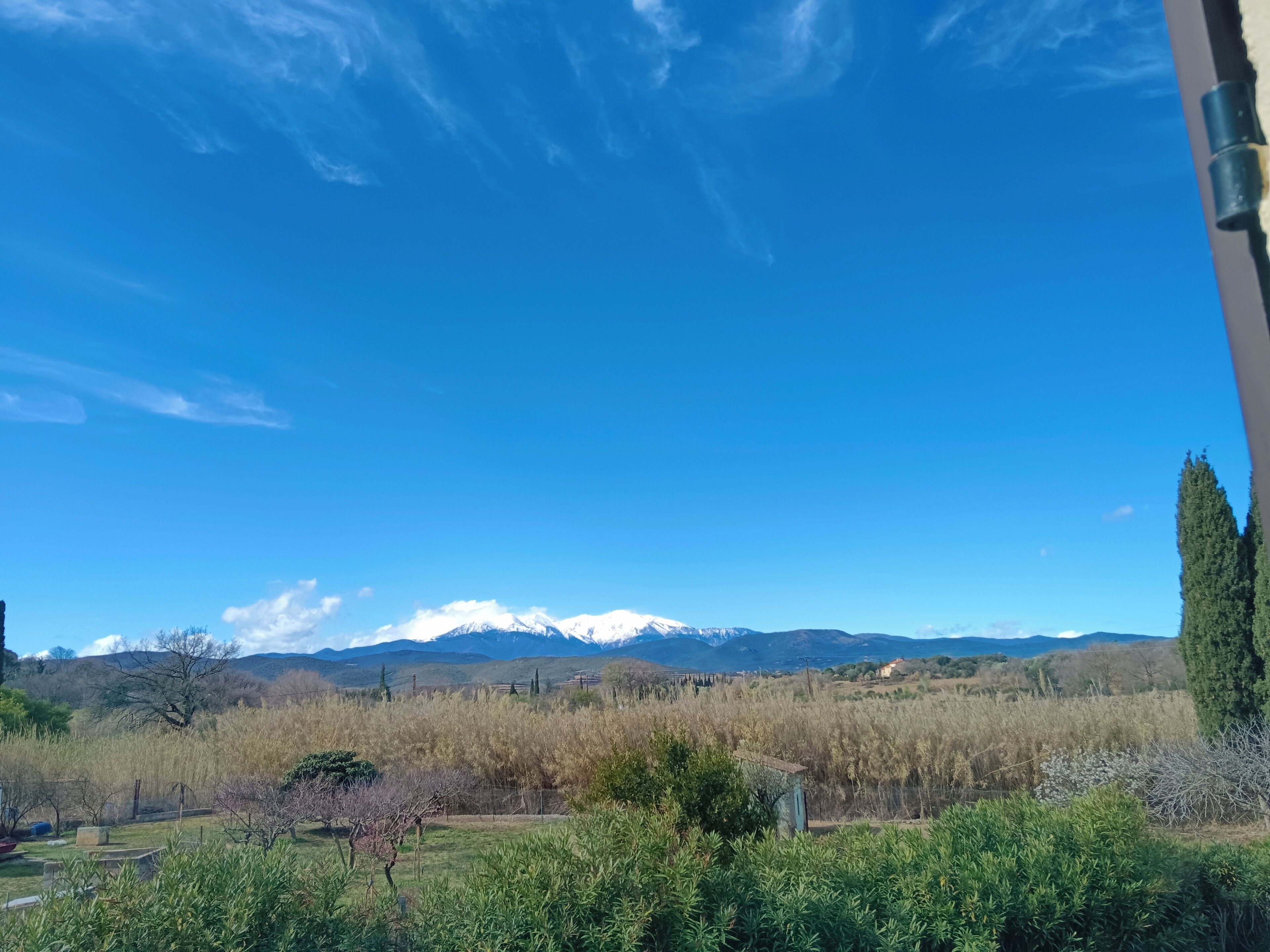 A view of a mountainous landscape with a clear sky.