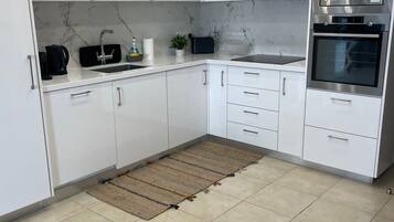 Deluxe Apartment, Balcony, Sea View | Private kitchen | Highchair