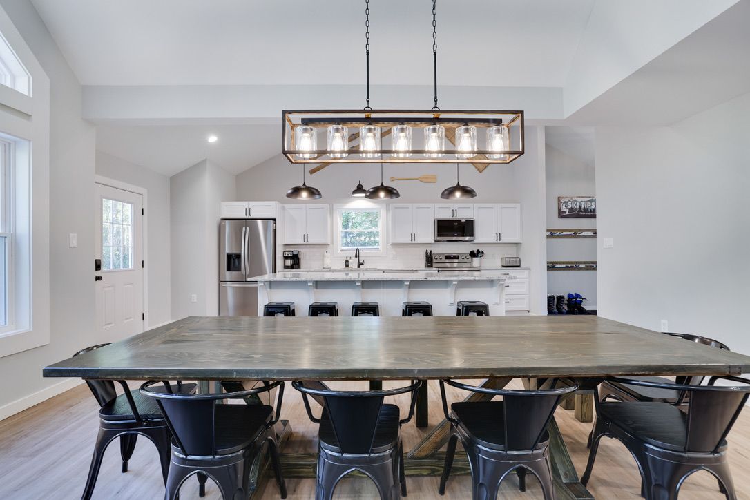 A spacious kitchen with a large island, modern appliances, and a pendant light fixture.