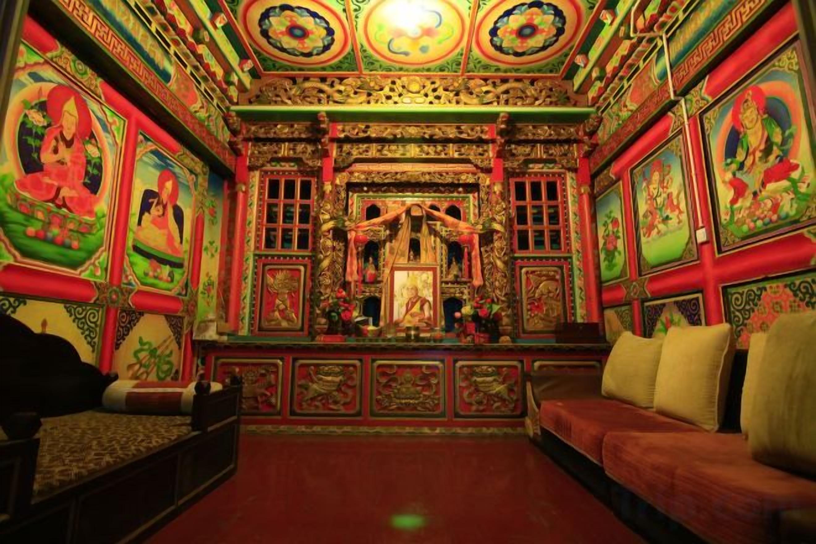 A room with a central altar, seating, and decorative walls.