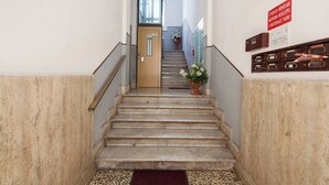 A staircase leading to a door with a sign indicating a deposit area for bicycles and materials. - The Traveler's House   (N. CITRA 011015-LT-1230) (La Spezia)