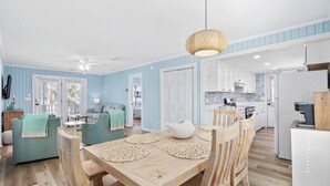 A modern kitchen with white cabinets, a coffee machine, and a refrigerator. - 2nd Row, Beach Cottage, 3BR/2BA!  (Murrells Inlet)