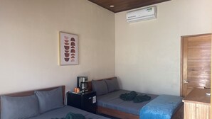 A room with two beds, a coffee maker, a heater, and a door. - Room Down Town Puerto Viejo CA04 (Puerto Viejo de Talamanca)