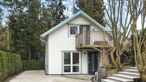 A two-story house with a balcony, a front door, and a driveway leading to a set of stairs. - 2 bedroom gorgeous home in åkersberga (Åkersberga)
