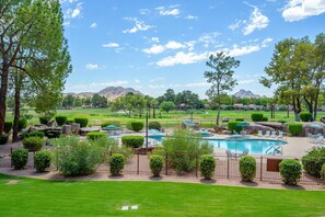 A pool area with lounge chairs and a view of a golf course and mountains. - CASA HAVEN - Anasazi Village - Full Golf Course View (Phoenix, Arizona)