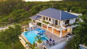 A two-story house with a swimming pool, surrounded by greenery. - Ripple Negril, The ultimate escape. Unpack, Relax, Enjoy, Ripple Negril, The ultimate escape (West End)