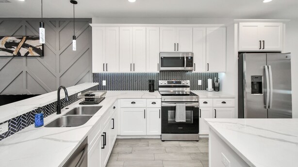 A modern kitchen with white cabinets, stainless steel appliances, and a herringbone-patterned backsplash. - Grand Luxé Retreat: Lux Home ★ GATED ★ FREE PARKING ★ Medical Center & NRG (Houston)