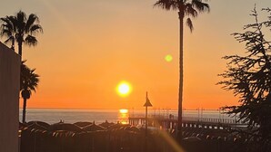 A sunset view with palm trees and a pier. - La Casa Sul Pontile (Marina di Vasto)