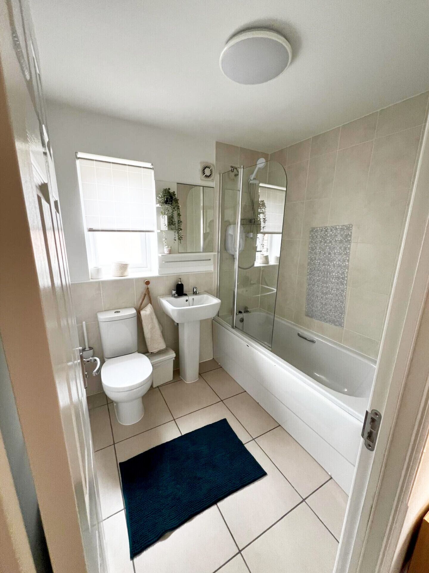 A bathroom with a toilet, sink, and bathtub.