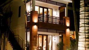 A two-story building with a balcony, large windows, and a staircase. - Green Bird Villa (Bali)