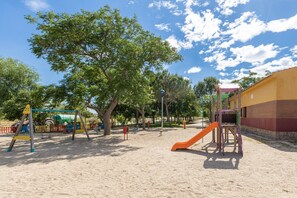 A playground with swings, slides, and climbing structures.