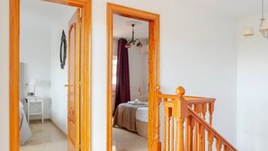 A hallway with wooden doors leading to a bedroom and a bathroom. - Holiday Home 'Villa Mansory' with Sea View, Wi-Fi and Air Conditioning (Lloret de Mar)