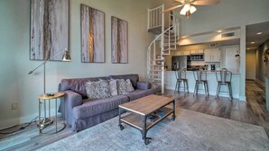 A modern living room with a sofa, coffee table, and artwork on the wall. - Lakefront Condo on Lake Conroe at The Lodge. (Montgomery)