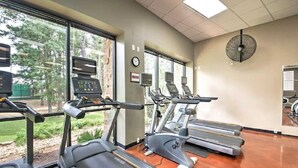 A gym with treadmills, elliptical machines, and a fan. - Lakefront Condo on Lake Conroe at The Lodge. (Montgomery)