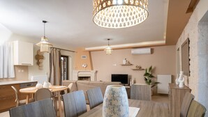 A modern dining area with a wooden table, chairs, and a decorative vase. - Holiday Home Timos Villa with Mountain View, Wi-Fi and Air Conditioning (Zakynthos)