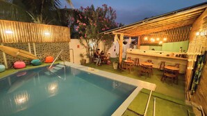 A pool area with a bar and seating. - Hotel Boutique Puerto (Máncora)